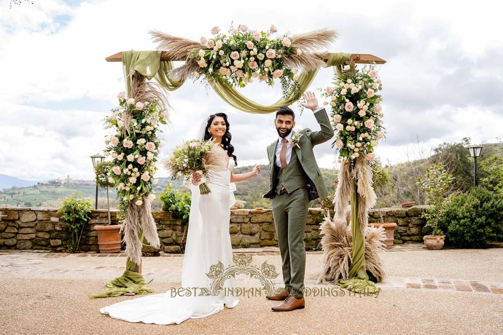 white dress ceremony floral arch